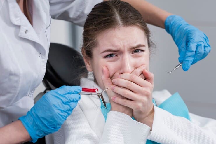 A Dental Doctor Treats A Patient Reclining In The Chair With Focused Precision.